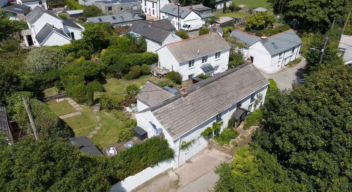 Old Kiddlywinks has a lovely large garden to relax in, you can see the parking for two cars to the left of the cottage. 