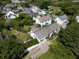 Old Kiddlywinks has a lovely large garden to relax in, you can see the parking for two cars to the left of the cottage.