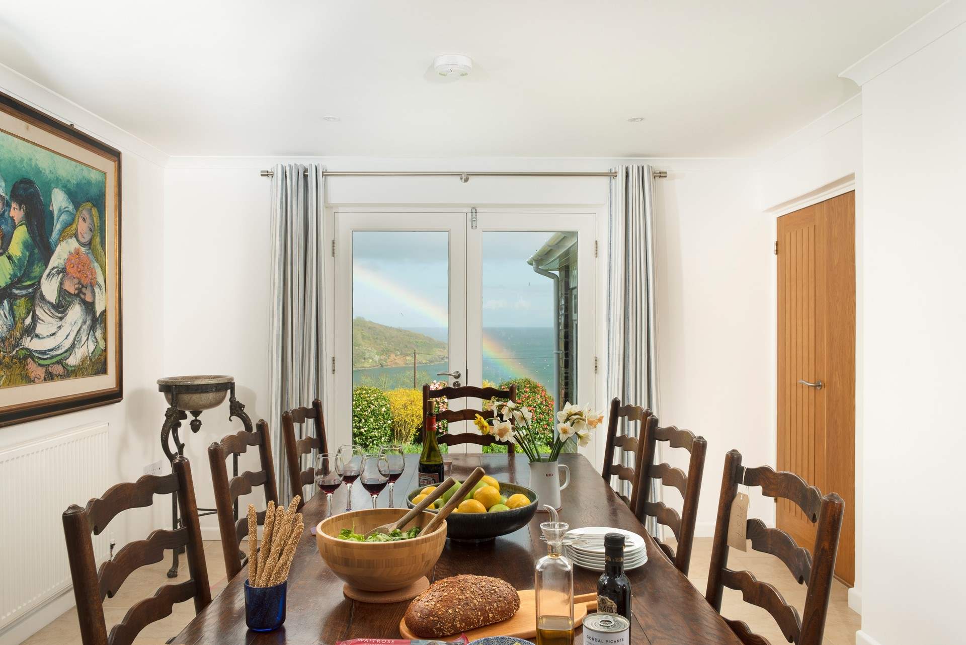 The double doors lead on to a patio area with an outdoor lounge set, perfect for al fresco breakfasts.