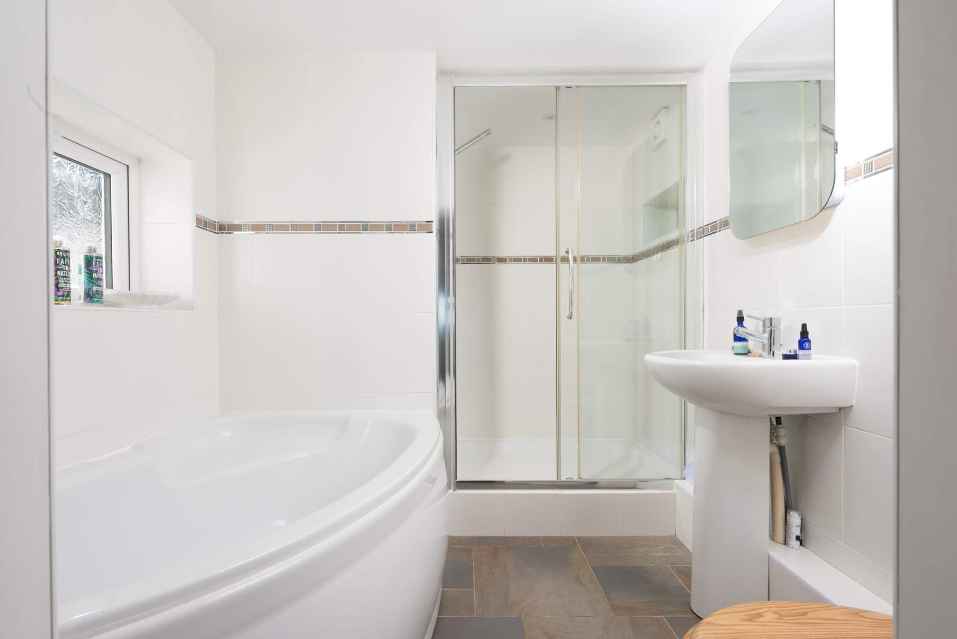 This is the spacious en suite to bedroom 3, complete with a separate bath and a glow mirror.