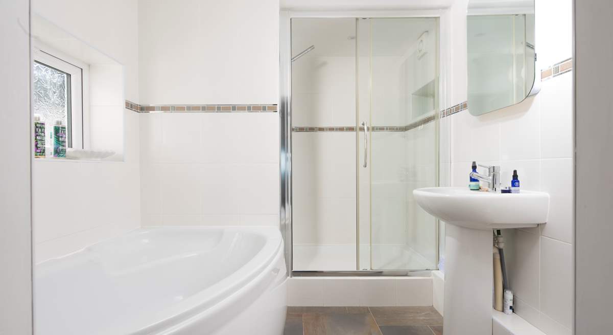 This is the spacious en suite to bedroom 3, complete with a separate bath and a glow mirror.