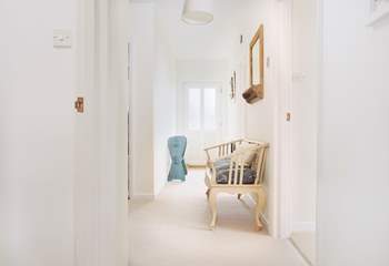 The lower ground floor hallway has a door to the side of the house and access to the lower terraces.