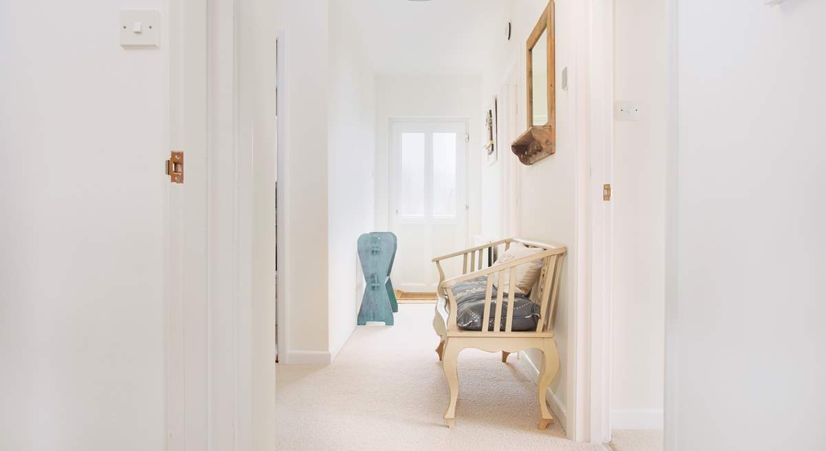 The lower ground floor hallway has a door to the side of the house and access to the lower terraces.