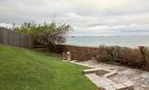 The stunning view of the Solent from the garden, with beach access below. - Thumbnail Image