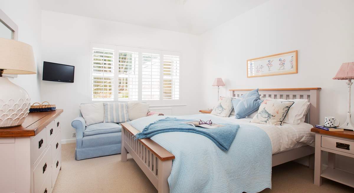 Charming bedroom 4 with a double bed and TV and views towards the garden and sea.  A little sanctuary.