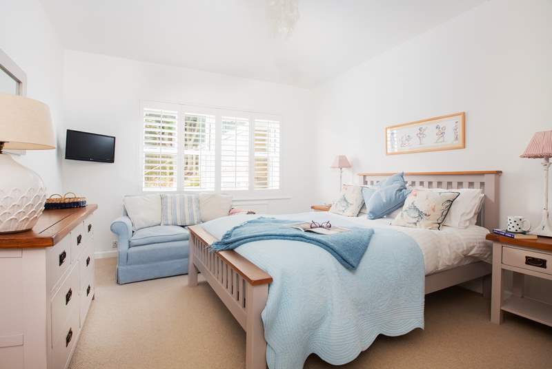 Charming bedroom 4 with a double bed and TV and views towards the garden and sea.  A little sanctuary.