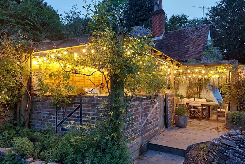 The festoon lighting makes the outdoor dining and kitchen area a great space to use into the evenings.