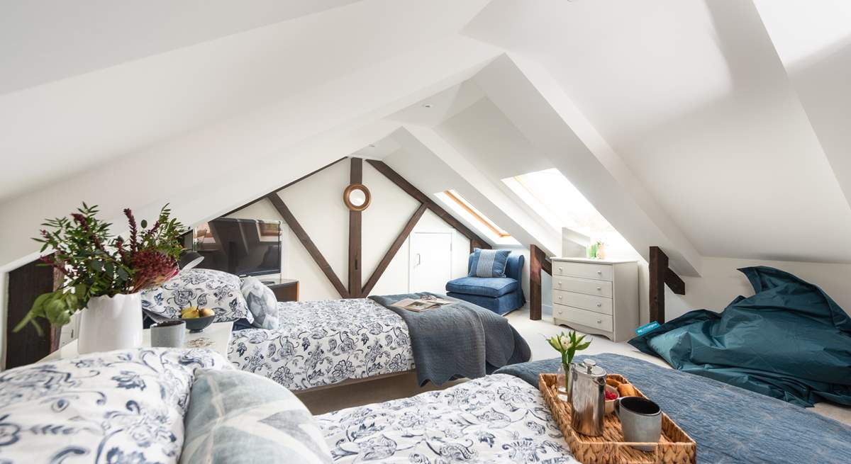 The bedroom is full of character set under the eaves.