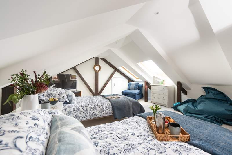 The bedroom is full of character set under the eaves.