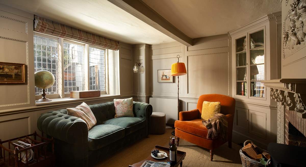 Sumptuous furnishings and a view through a leaded window to St Mary's Church.
 