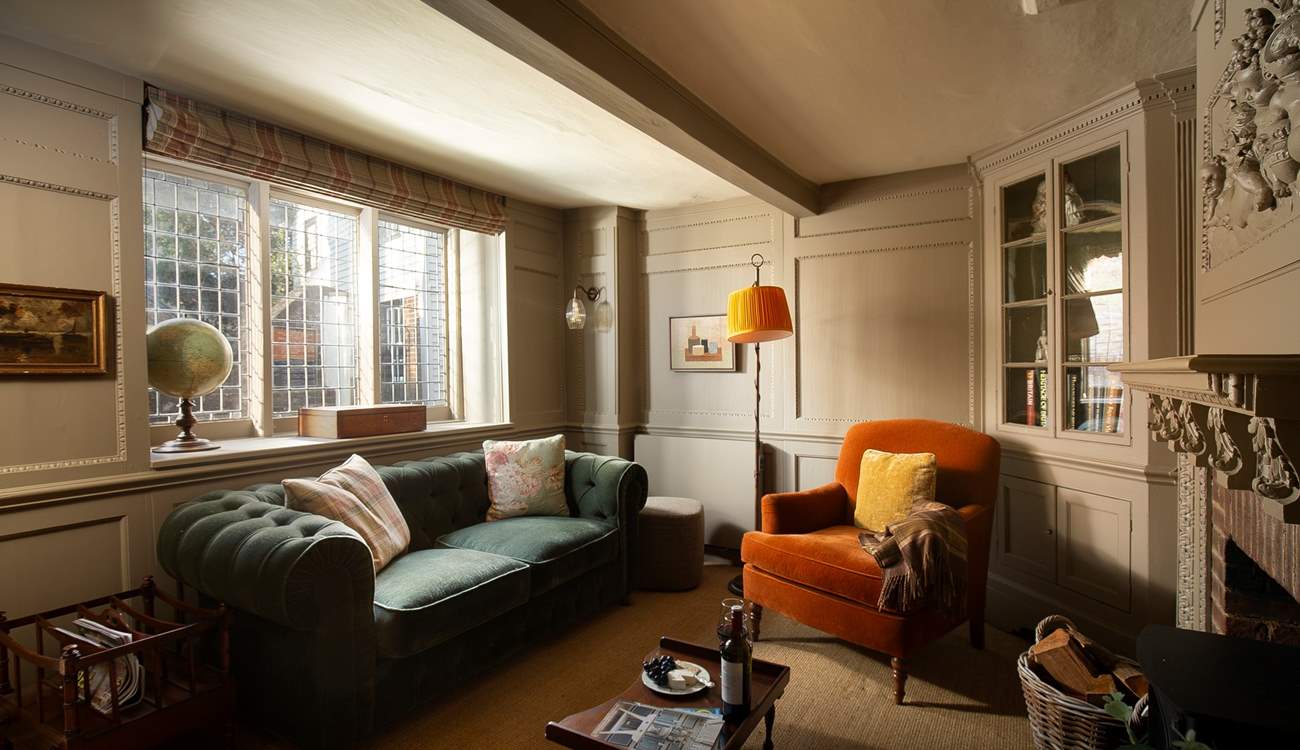 Sumptuous furnishings and a view through a leaded window to St Mary's Church.
 