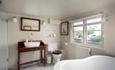 The bathroom is stylishly fitted with a shower cubicle and slipper bath. - Thumbnail Image