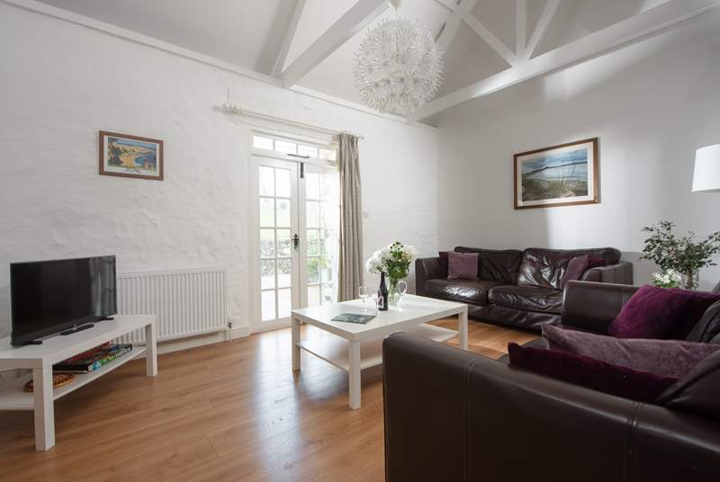 The superb sitting-room has double doors to let the fresh Cornish air in.