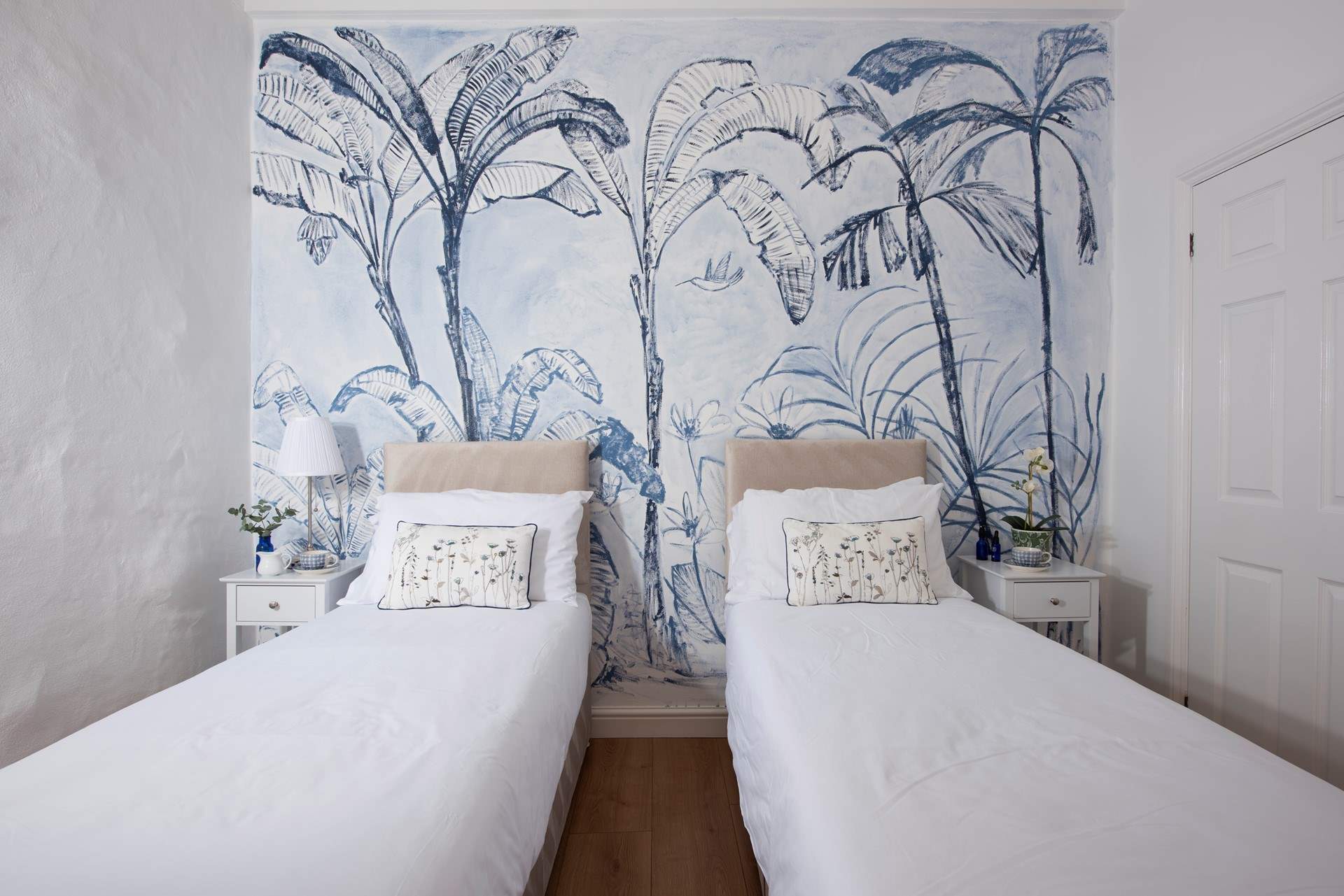 The mural in this bedroom is so captivating.