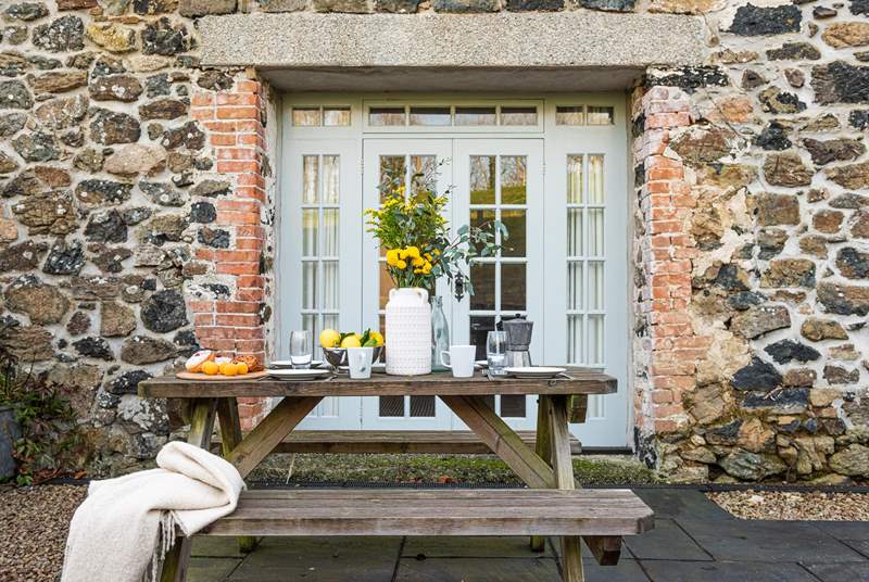 The picnic table is just off the sitting-room and is a great spot to relax. I love the gorgeous granite lintels.