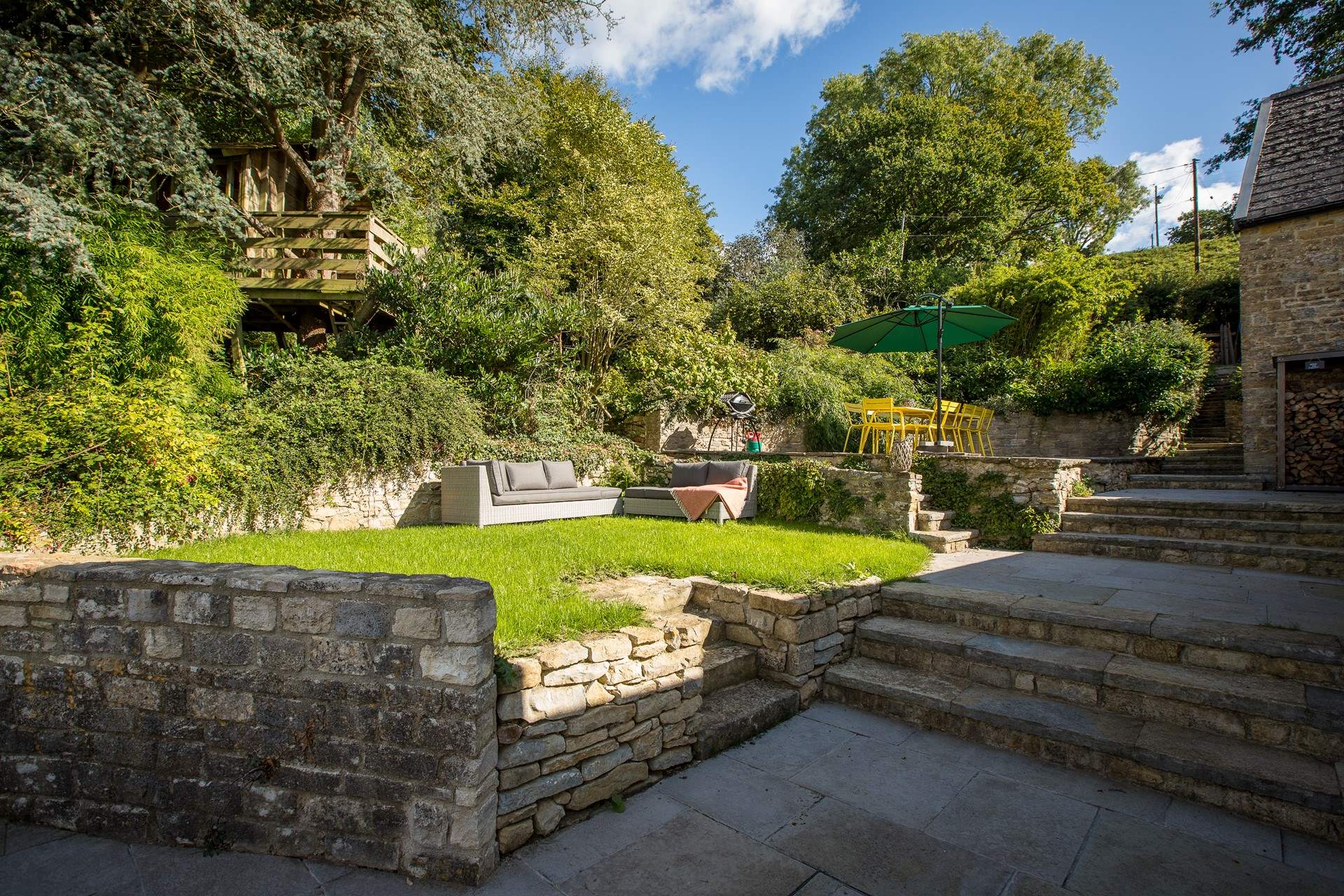 Dining al fresco is a must in this wonderful garden, complete with a tree-house. Hide and seek has never been so much fun!