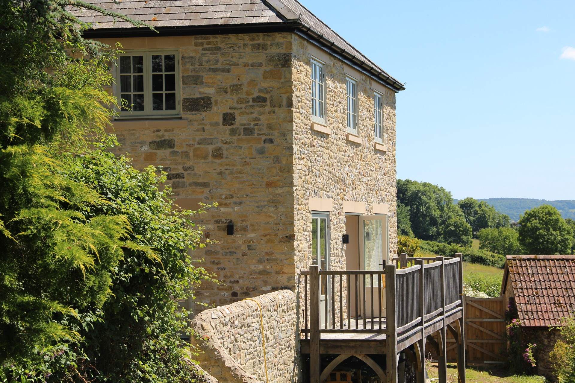 Glorious views can be enjoyed for miles. Step out of the kitchen onto this raised decking area to enjoy your morning coffee in style.