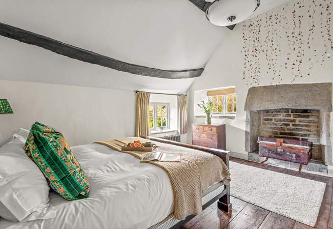 Bedroom 1 boasts a fabulous old stone fireplace.