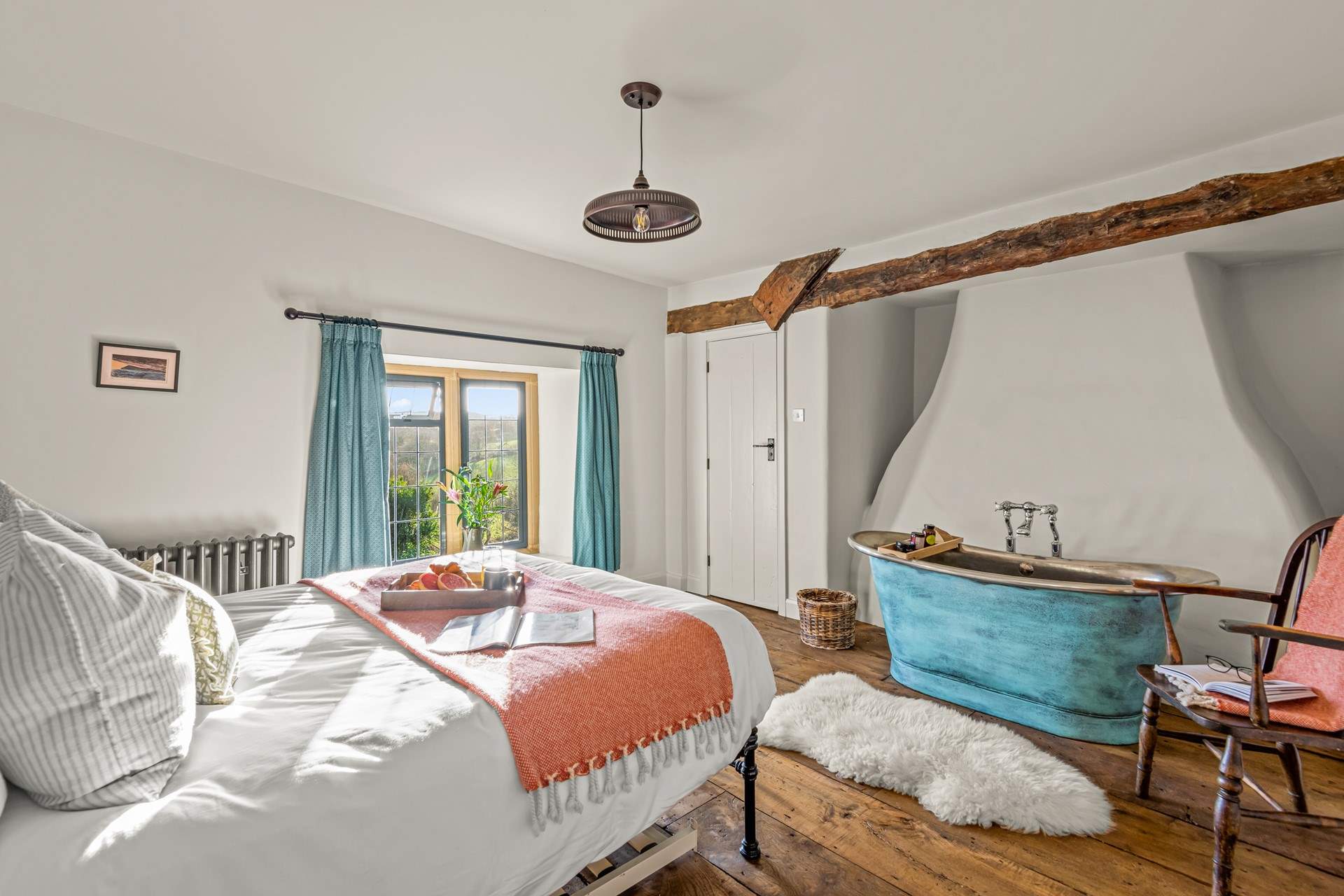 Bedroom 3 is home to a glorious king-size bed and roll-top bath.