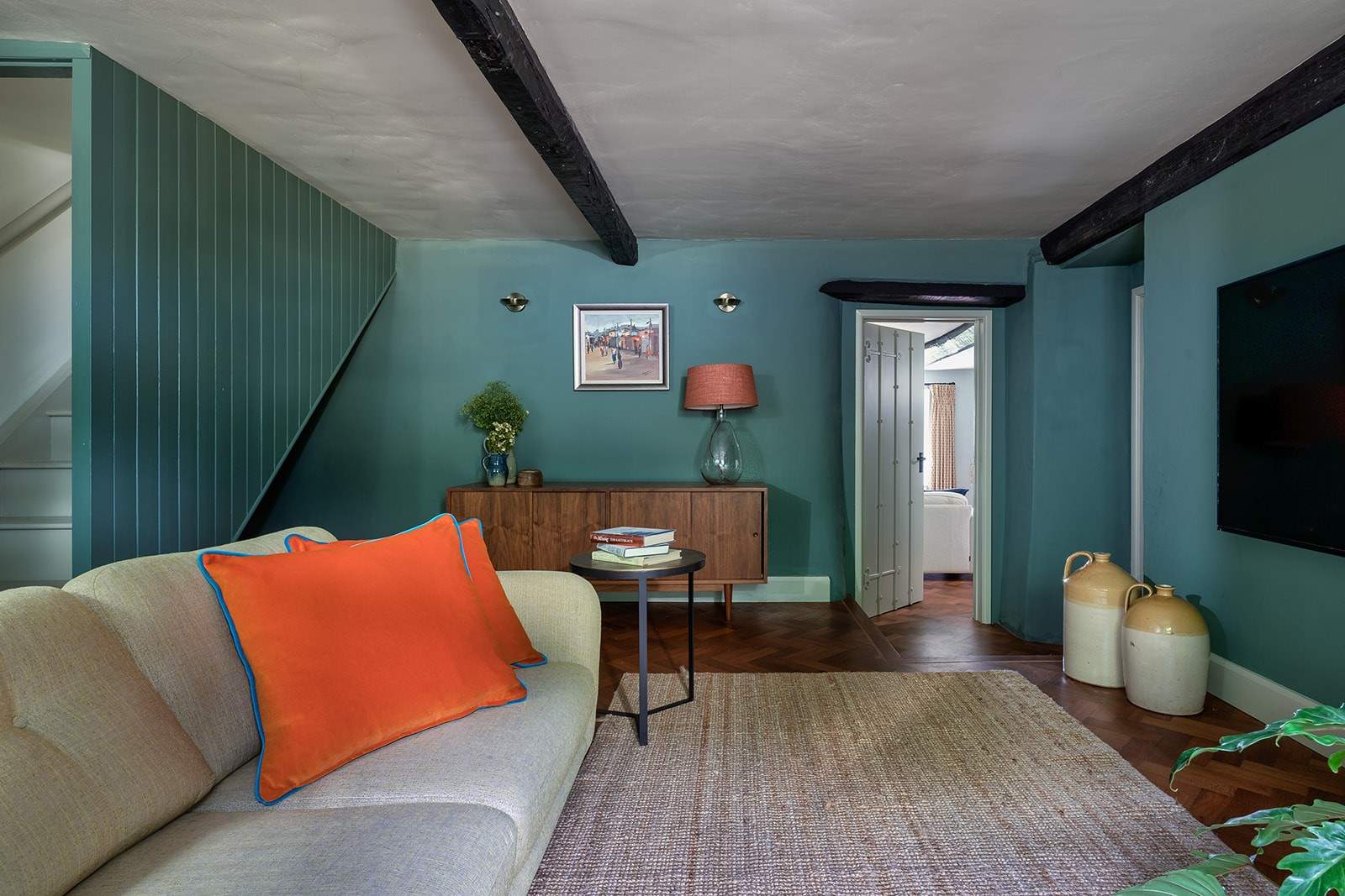 The snug TV room leads perfectly to the main living area.