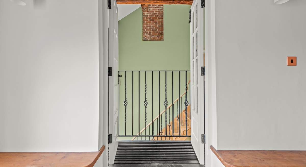 Peek through this quirky balcony into the hallway.