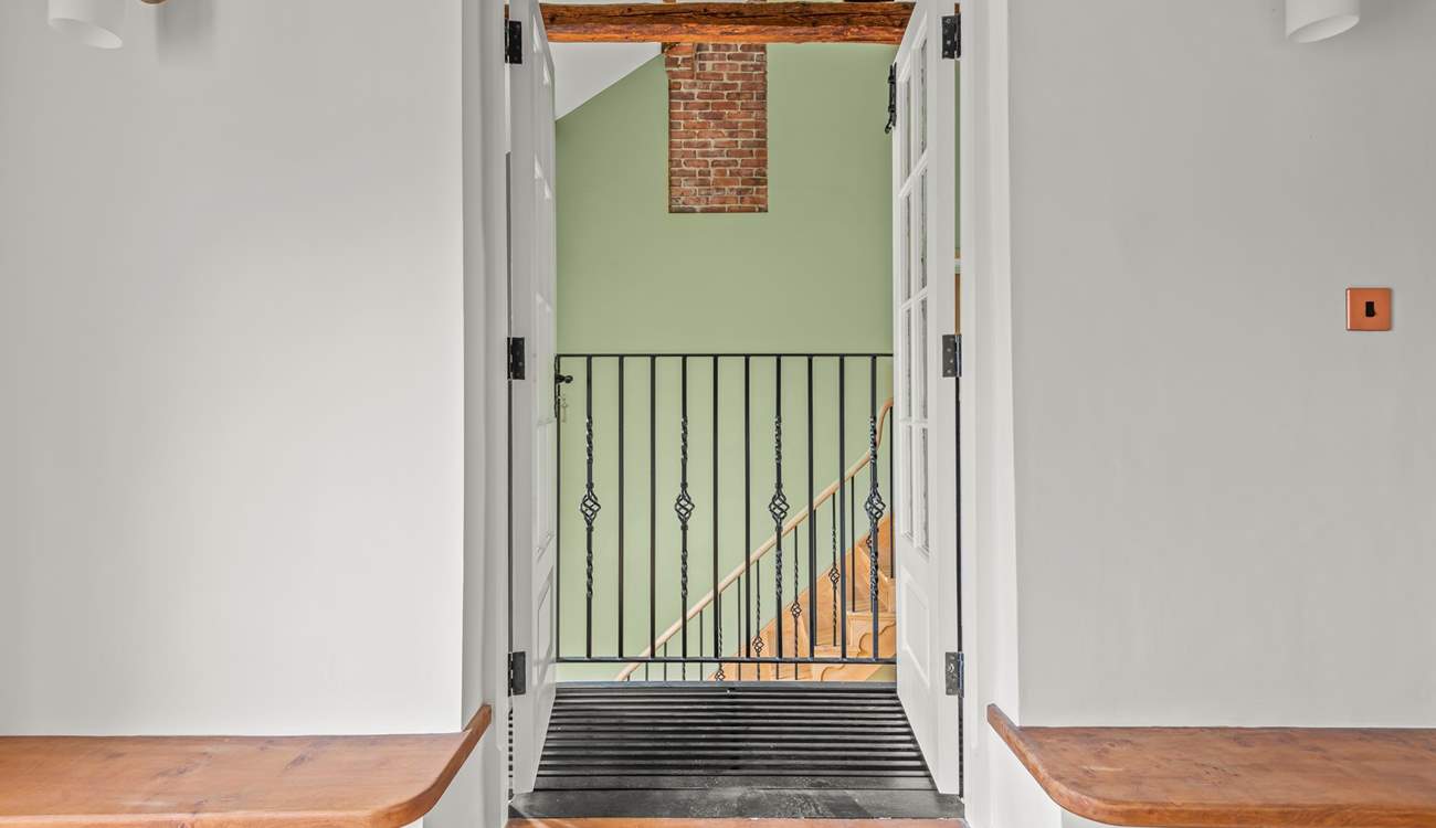 Peek through this quirky balcony into the hallway.