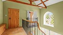 The sweeping staircase takes you to this light and airy landing, which also has superb views.