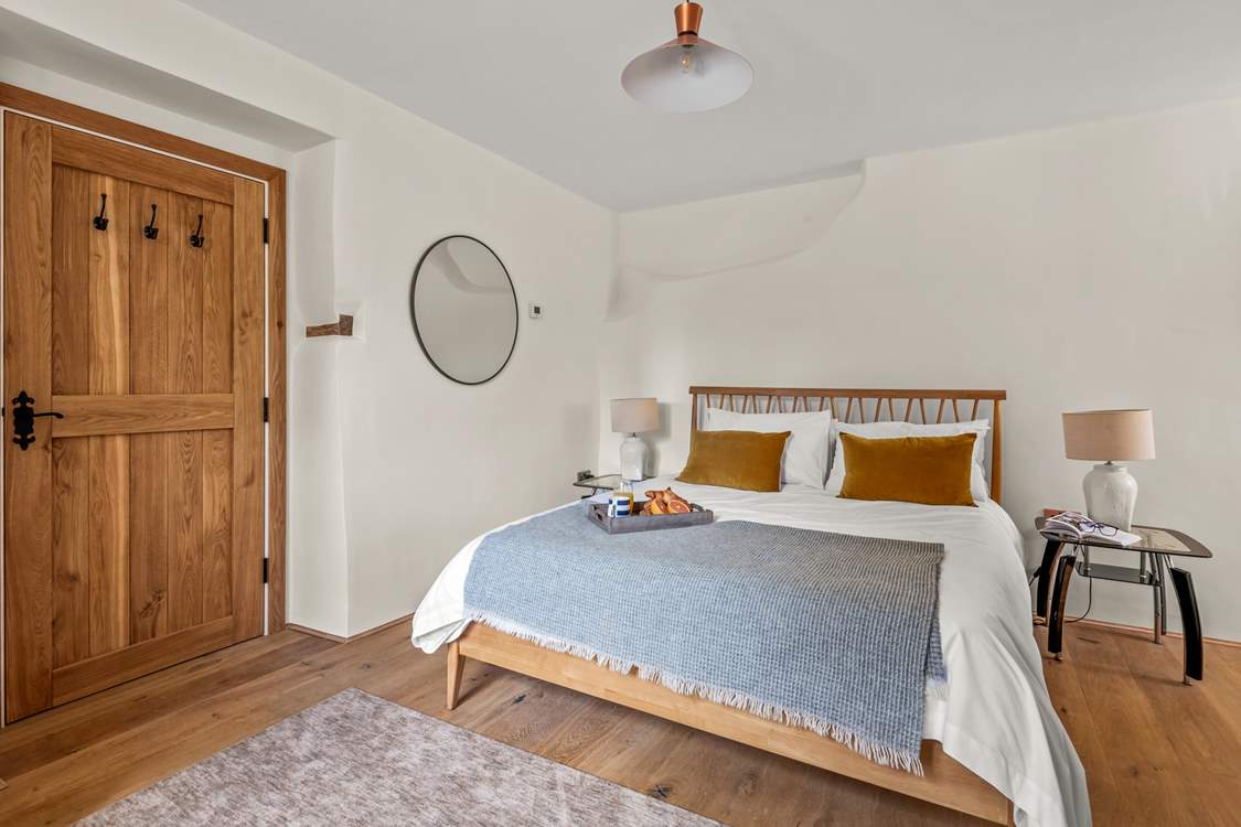 Super comfy King-size bed awaits you in Bedroom 1.