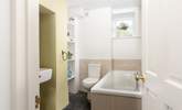 The bathroom is on the ground floor and features a bath with a separate shower cubicle. - Thumbnail Image