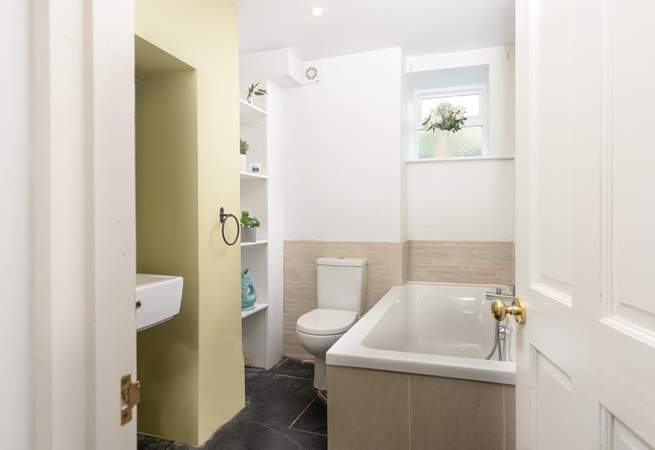 The bathroom is on the ground floor and features a bath with a separate shower cubicle.