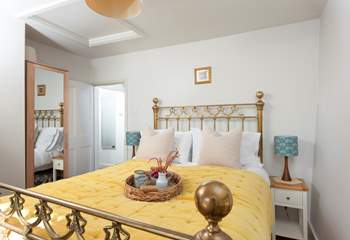 Bedroom 1 features a magnificent brass bed.