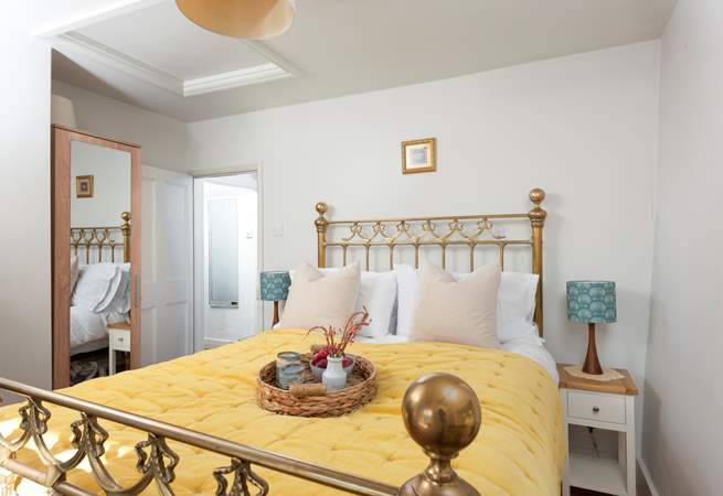 Bedroom 1 features a magnificent brass bed.