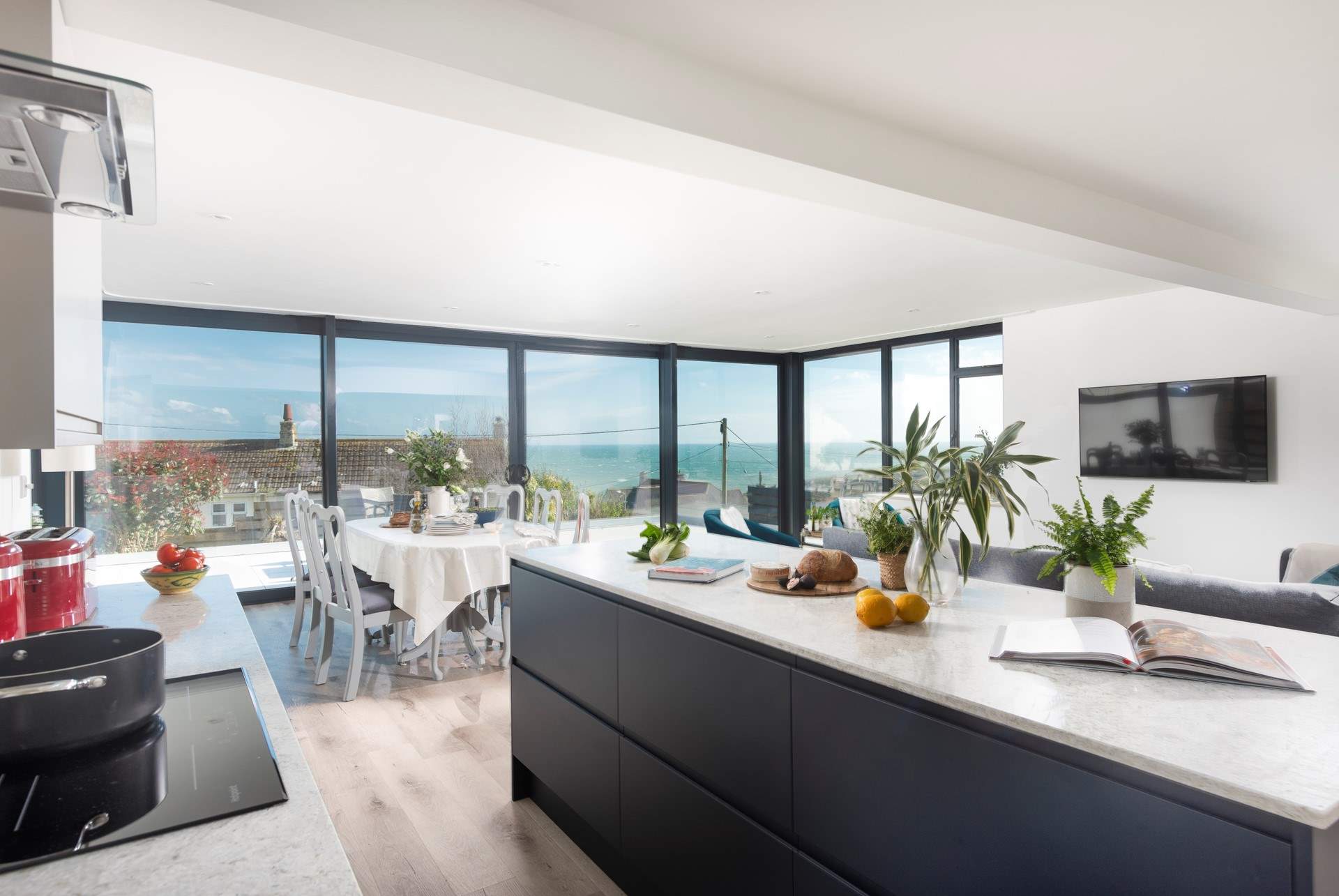 The stylish open plan living-room with kitchen and dining areas. 