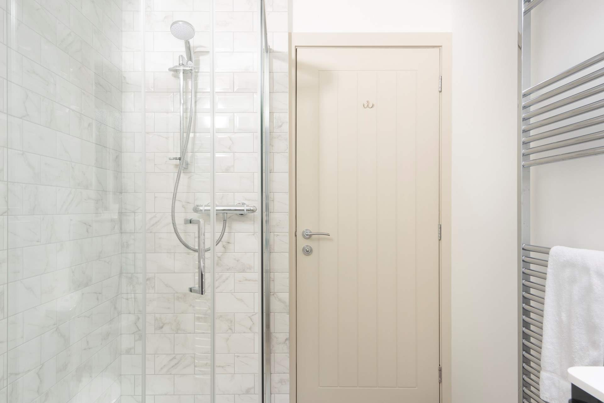 With a shower cubicle. 