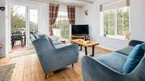 Flooded with natural light and panoramic views, the sitting room is a joy. 
