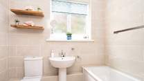 Attractive family bathroom with overhead shower. 