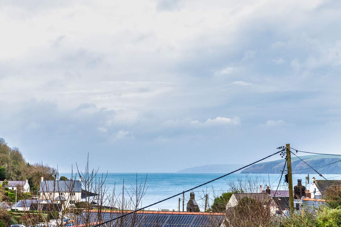 Gaze out across the pretty sea view from the sitting-room, garden and the two double rooms.