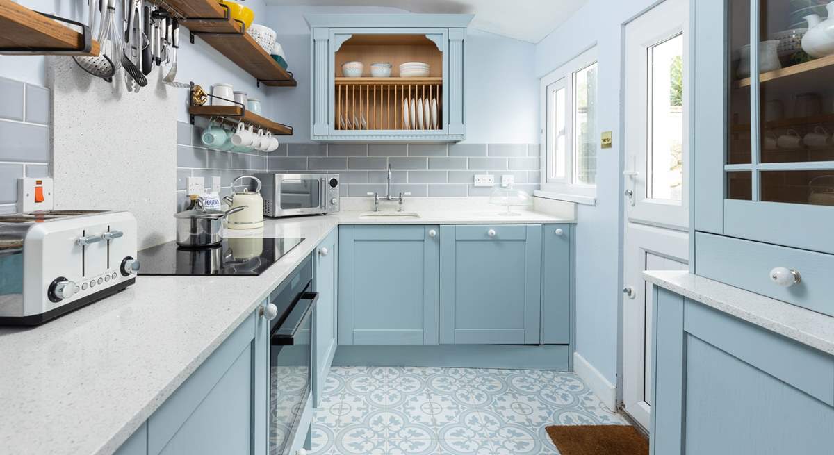 The kitchen, in hues of powder blue, has everything you need. 