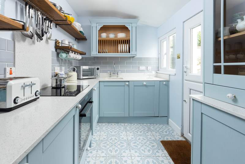 The kitchen, in hues of powder blue, has everything you need. 
