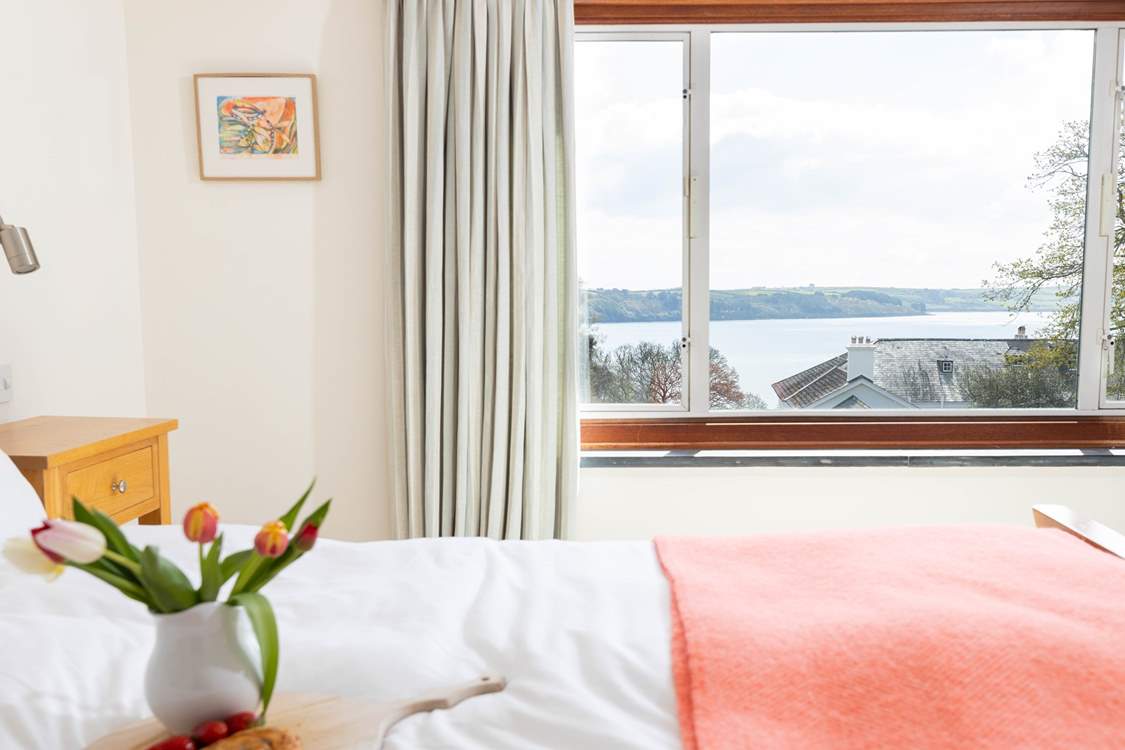 Enjoy watching the sea sparkle from the comfort of your bed.