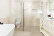 The large en suite for bedroom 1 has a walk-in shower and a beautiful free-standing bath.