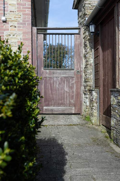 The old gate leads from the terrace to the garden.