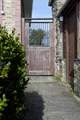 The old gate leads from the terrace to the garden.