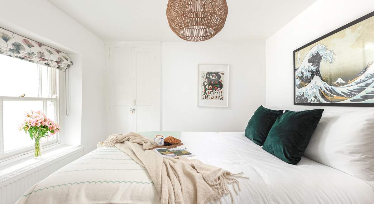 Muted calming tones help you drift off to sleep in this gorgeous bedroom.