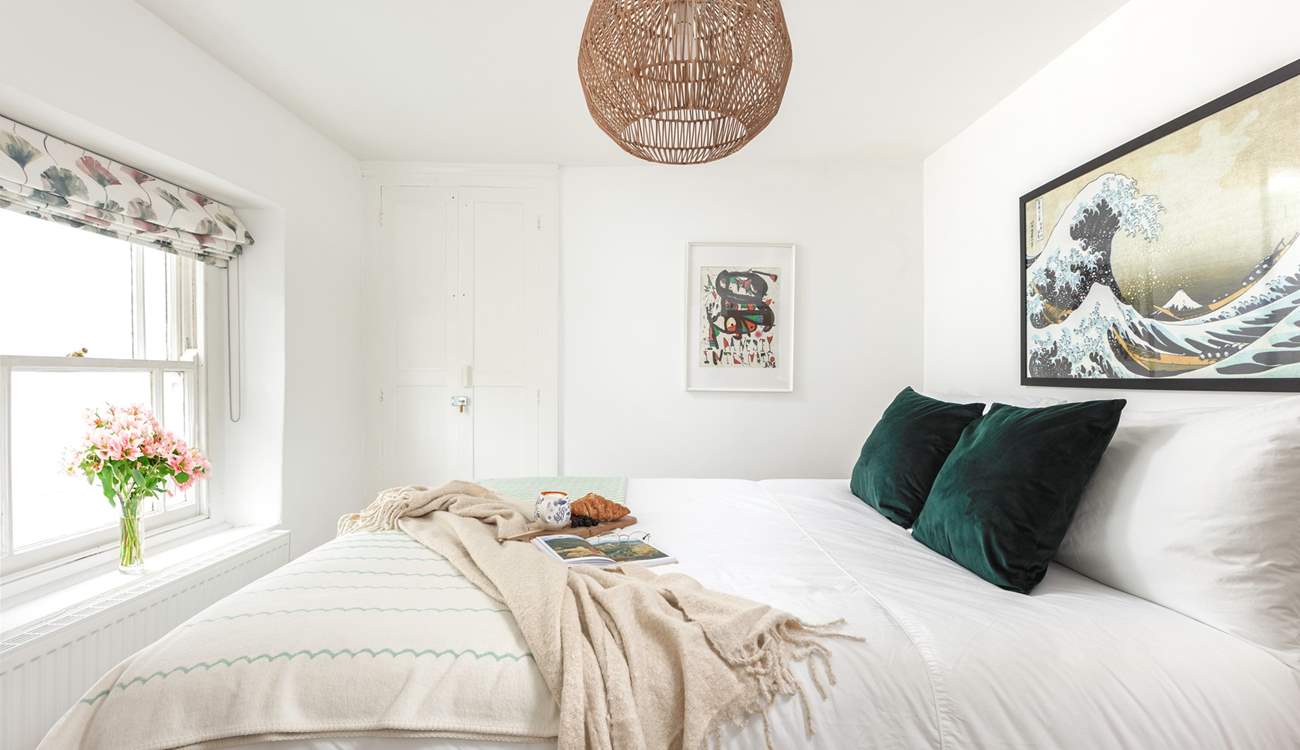 Muted calming tones help you drift off to sleep in this gorgeous bedroom.