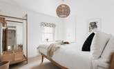 Muted tones and a cosy bed cam be found in bedroom one. - Thumbnail Image