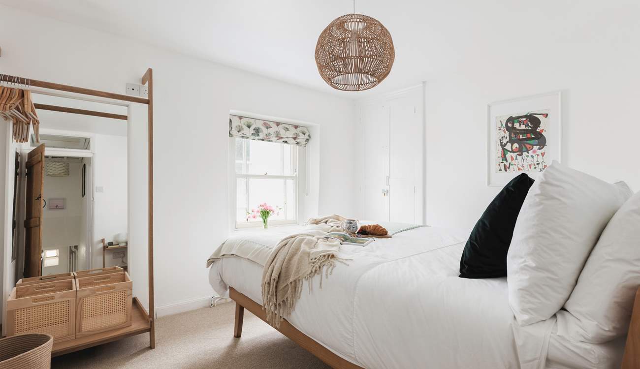 Muted tones and a cosy bed cam be found in bedroom one.