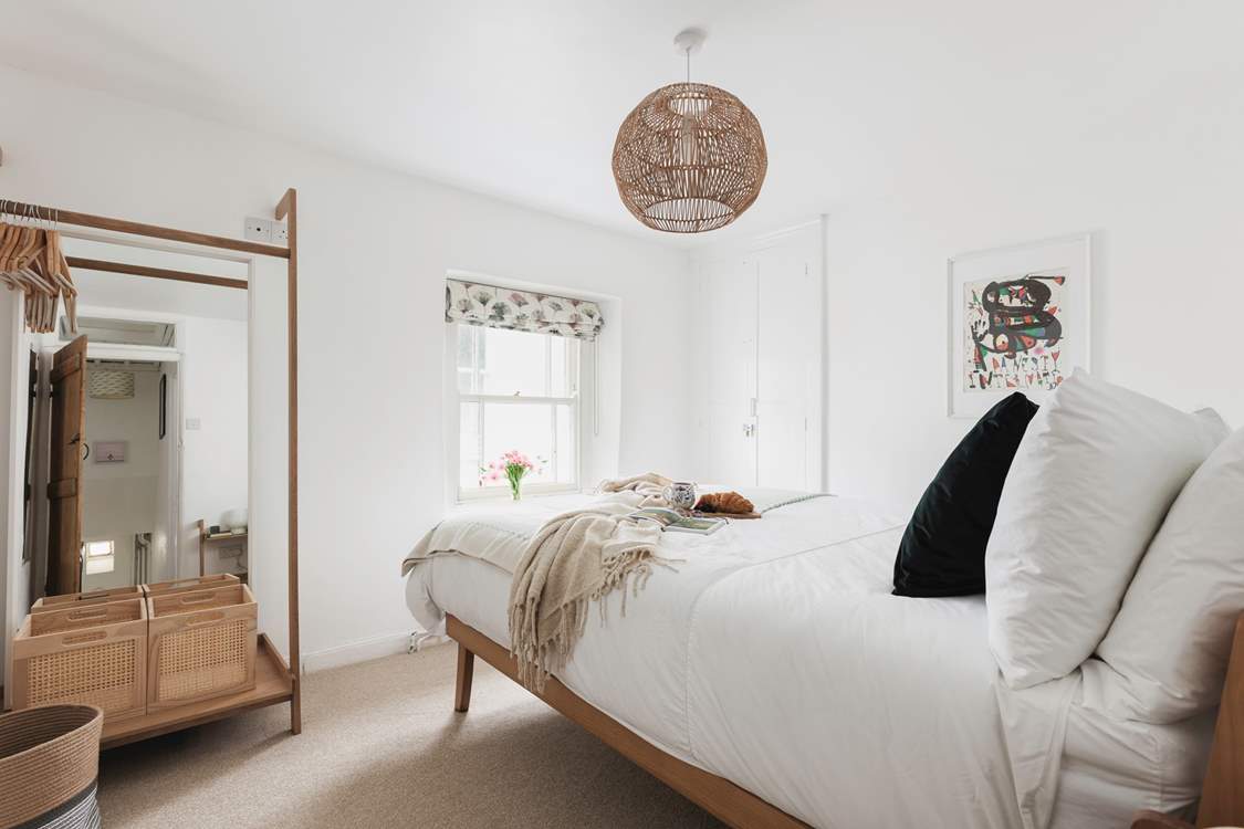 Muted tones and a cosy bed cam be found in bedroom one.