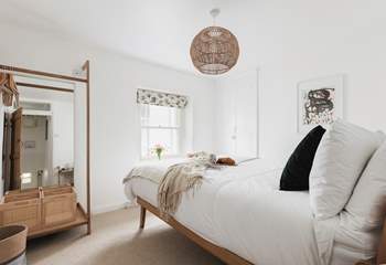 Muted tones and a cosy bed cam be found in bedroom one.