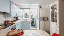 From the kitchen you can access the garden as well as the downstairs bathroom.